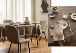 Dining table with upholstered chairs, table setting and linen textiles.