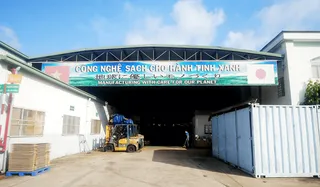 Exterior of a furniture factory with warehouse entrance and forklift