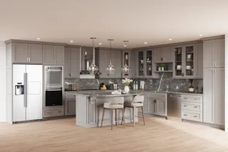 Gray fitted kitchen with island, appliances and stone backsplash
