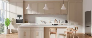Light-colored fitted kitchen with island, cabinetry and dining stools