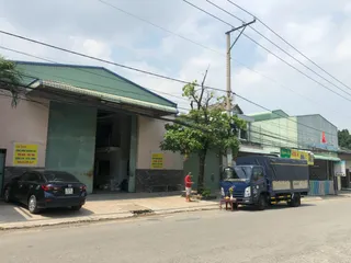 Street view of a manufacturing workshop with trucks outside