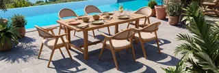 Wooden outdoor dining table and six chairs beside the sea