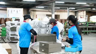 Workers assembling furniture at a production facility