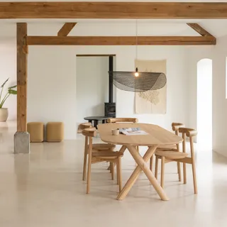 Wood dining table and chairs in a bright interior