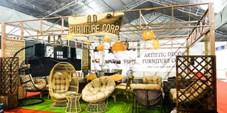 Artistic Decor Furniture exhibition booth displaying wicker chairs, sofas, tables and screens