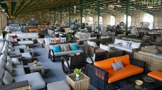 Large indoor furniture facility filled with outdoor sofas, chairs and tables