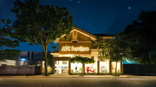 Illuminated ATC Furniture showroom exterior at night
