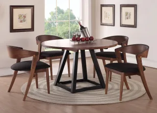 Round dark wood dining table with four curved-back chairs