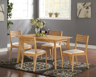 Wooden dining table with four ladder-back chairs and upholstered seats
