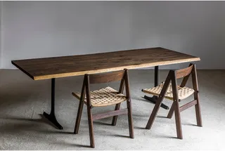 Solid-wood dining table with two woven-seat wooden chairs
