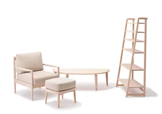 Light wood armchair, footstool, coffee table and shelving unit.