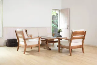 Upholstered wooden lounge chairs and coffee table in a bright room.