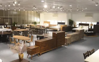 Furniture showroom interior with dining tables, chairs, beds, sofas and wooden cabinets