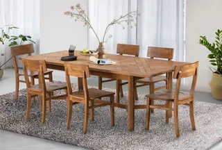 Wooden dining table with six matching chairs in a bright room
