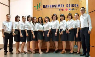 Company staff standing together beneath a company sign