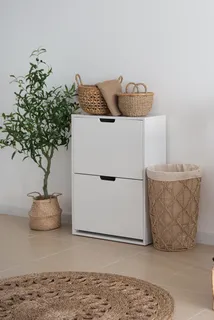 Woven baskets and round rug beside a white storage cabinet