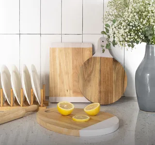 Wooden cutting boards and kitchen utensils arranged on a counter