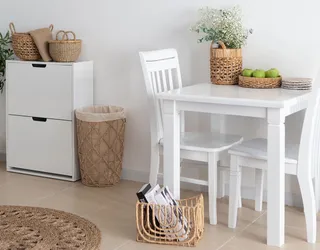 Woven baskets, storage container and rug in a bright dining room