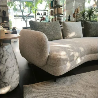 Light upholstered sofa displayed in a bright furniture showroom