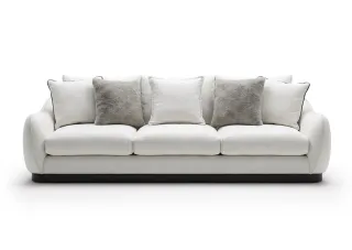 Large white three-seat sofa with multiple cushions