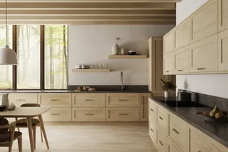 Light wood kitchen cabinetry with dark countertops in a finished interior