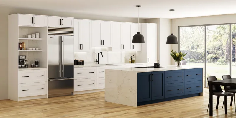White and navy kitchen cabinets with island, marble countertop and pendant lights