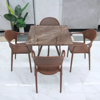 Brown dining table and four matching chairs in a bright interior