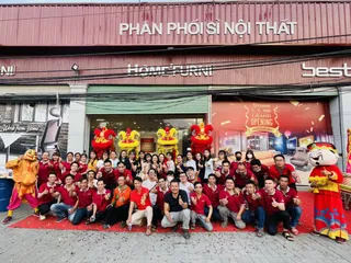D'Furni team gathered outside a furniture showroom during a grand opening