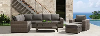 Brown woven outdoor sofa set arranged beside a swimming pool
