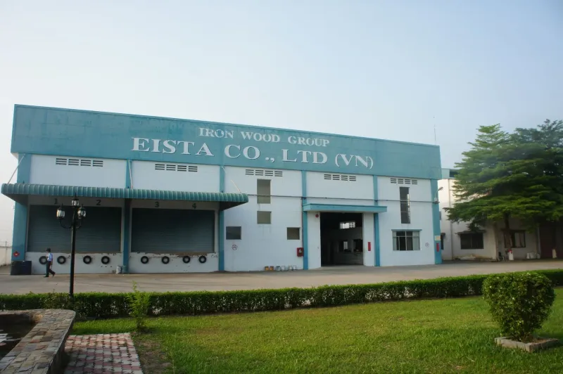 Exterior of EISTA Co., Ltd. factory building with landscaped grounds