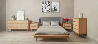Wood platform bed, bedside tables, dressers and cabinet in a bedroom