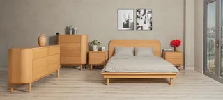 Wood bed, bedside tables, dresser and tall cabinet in a bedroom