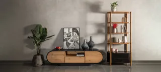 Rounded wooden sideboard and open shelving unit against a textured wall