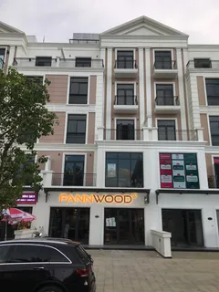 Fannwood storefront in a multi-story building with visible illuminated signage