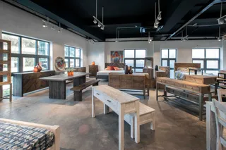 Showroom with wooden tables, benches, beds and storage furniture