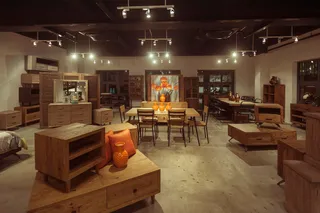Interior showroom filled with wooden bedroom, dining and storage furniture