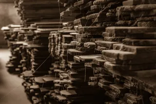 Stacks of rough reclaimed timber boards in a storage area