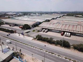 Aerial view of a large industrial factory complex with loading docks