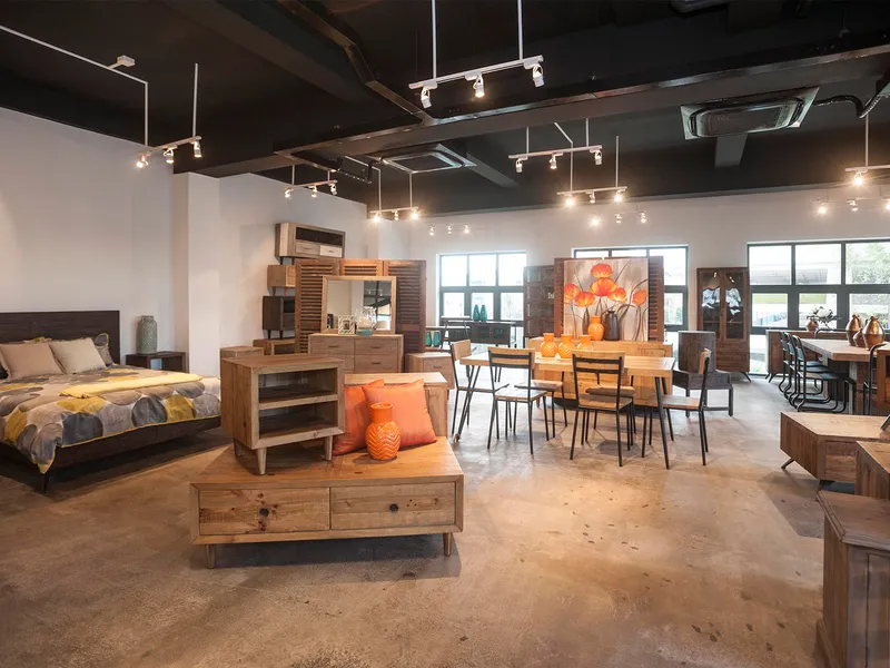 Furniture showroom displaying beds, tables, cabinets and wooden seating