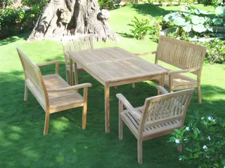 Wooden outdoor dining table and four matching chairs on a lawn