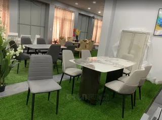 Greenfurni showroom with marble-top dining tables and upholstered dining chairs