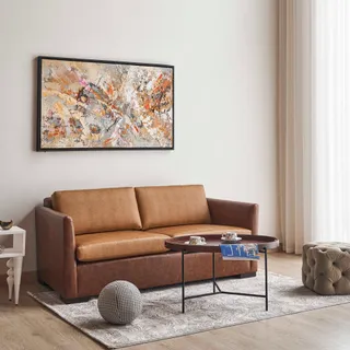 Brown upholstered sofa with round coffee table in a living room