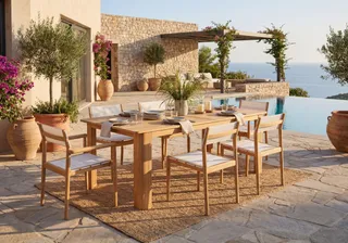 Wooden outdoor dining table and chairs beside a swimming pool