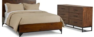 Dark wood platform bed with beige bedding beside a matching six-drawer dresser.