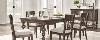 Dark wood dining table with six chairs, bench and matching sideboard.