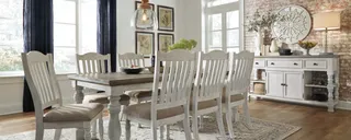 White painted dining table with six chairs and matching sideboard.