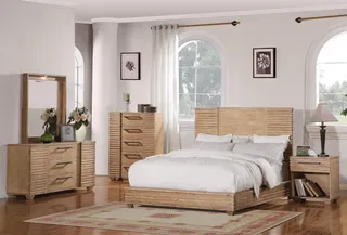 Wood bedroom set with bed, dressers, mirror, and bedside table in a bright room.