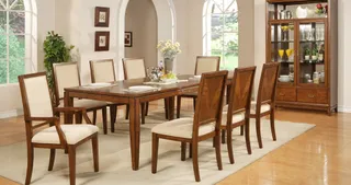 Dark wood dining table with upholstered chairs and glass-front display cabinet.