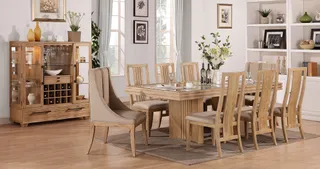 Wood dining table, chairs, upholstered armchair, and display cabinet in a furnished room.