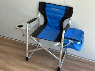 Blue folding camping chair with attached side table